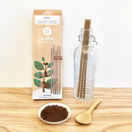 EQUO extra long coffee drinking straws in brown box and 3 straws inside a glass bottle. Made with coffee grounds, 100% natural and compostable.