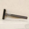 Matted black gold zinc alloy safety razor placed on side view with minimal background.