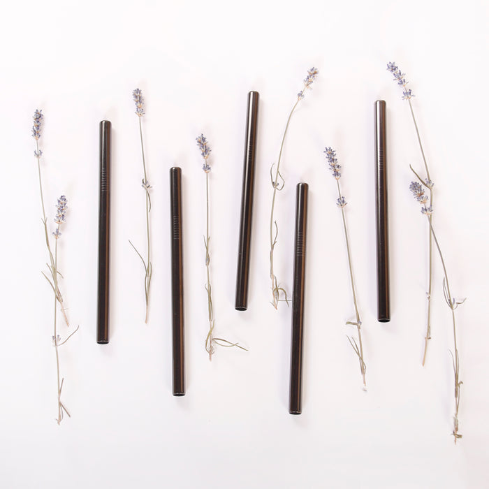 Black stainless steel boba straws flat lay with lavenders.