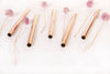 Rose gold stainless steel boba straws assorted with chive blossoms.