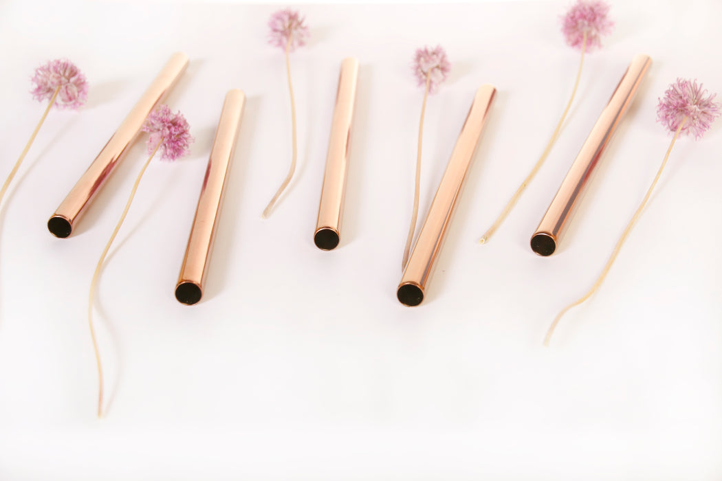 Rose gold stainless steel boba straws assorted with chive blossoms.