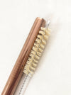 Rose gold stainless steel boba straw with natural sisal straw brush set in white background.