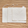 Set of 3 cotton bulk food bags on top of each others. Size measures: 28x20cm/28x33cm/28x43cm.