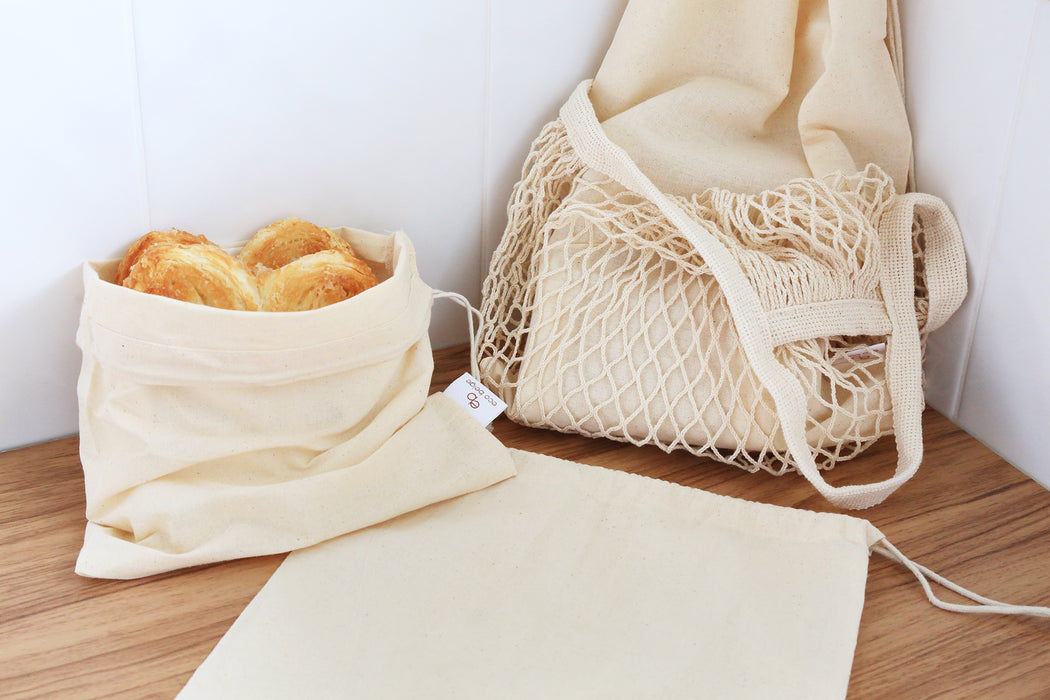 Cotton bulk food bag holding pastry goods side along with other natural cotton bag display