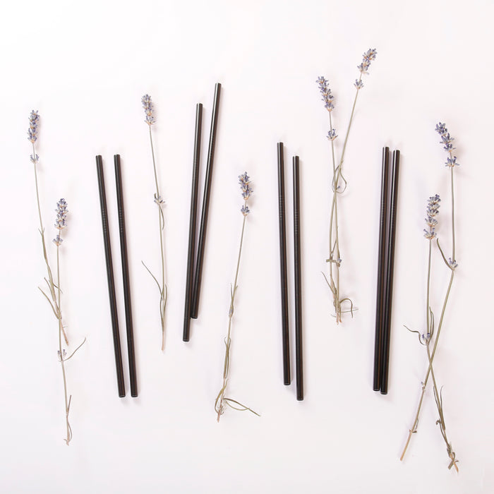 Black stainless steel straws flat lay with lavenders.