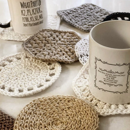 Beige themed crochet coasters handmade in Richmond. Mugs placed on coasters.