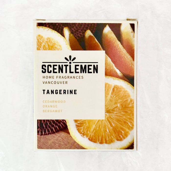 Scentlemen Studio tangerine scent candle box package. White crumbled paper background.