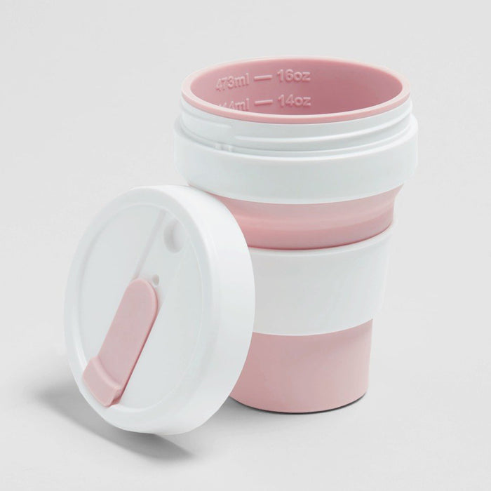 Rose color Stojo cup in 16oz. Lid off top angled view with ml and oz capacity bar showing inside. White background.