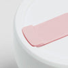 Rose color Stojo cup in 16oz. Close-up lid view with mouth tab. White background.