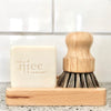 Kitchen sink with natural solid dish soap and natural bamboo coconut bristle scrub standing on the bamboo soap dish.